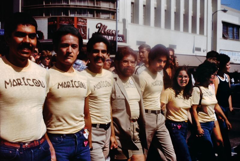 Participants in the Christopher Street West Pride parade wearing Joey Terrill’s malflora and maricón T-shirts, June 1976. Photo by Teddy Sandoval. Courtesy of Paul Polubinskas